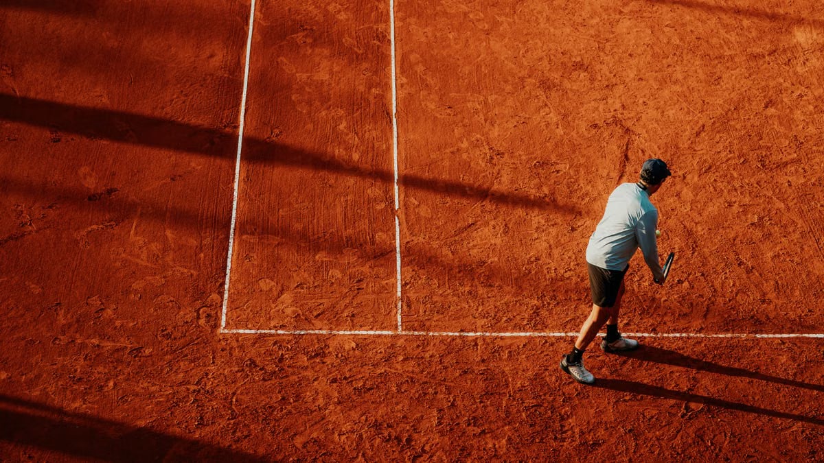 Tennis player preparing to serve on a clay court in Buenos Aires, Argentina.